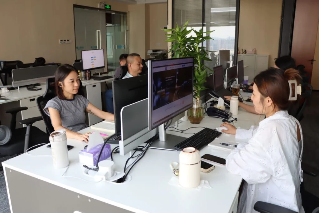 Office team working at computer workstations in a shared office