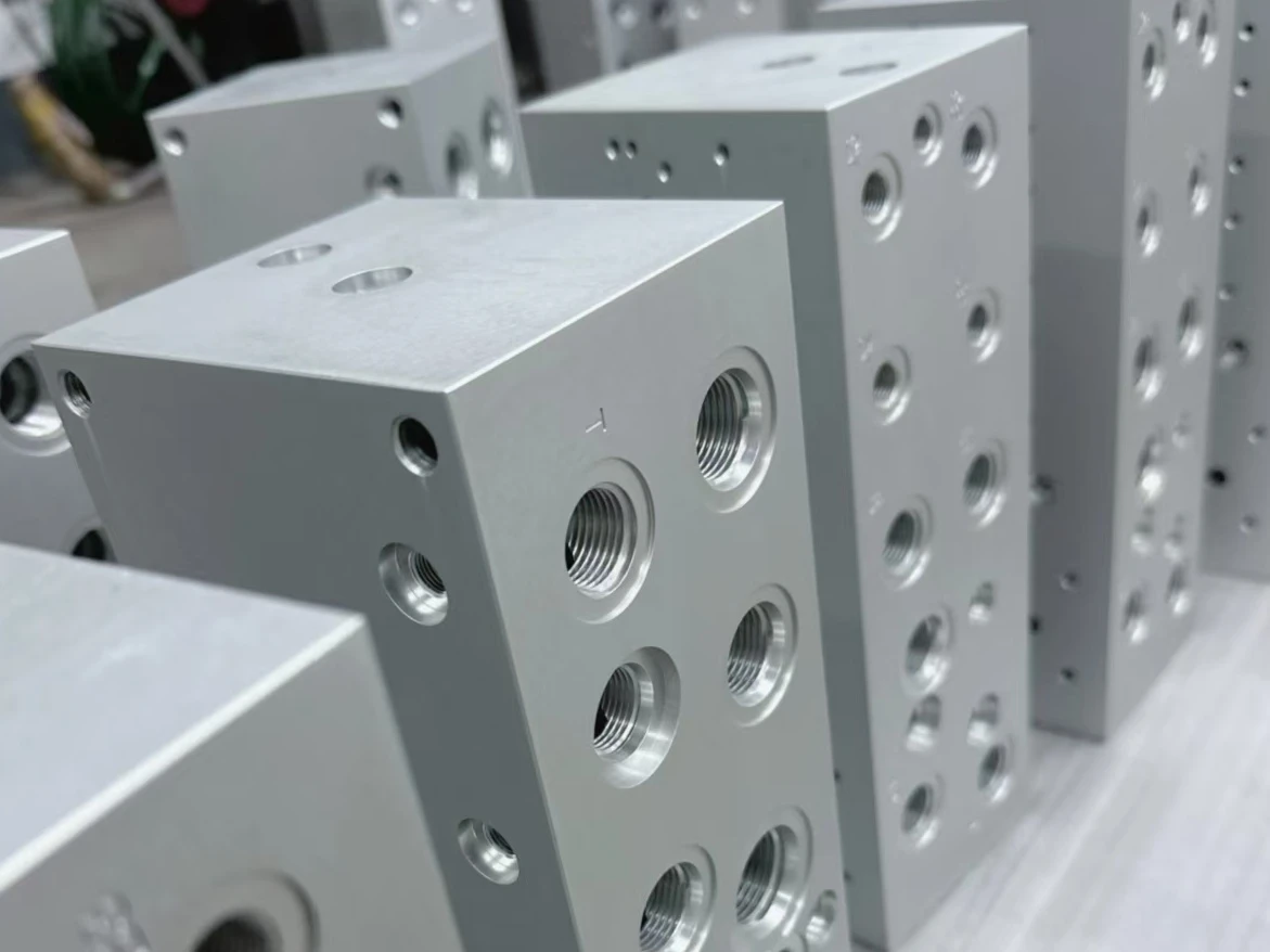 Natural-colored anodized metal blocks with threaded bores and side holes