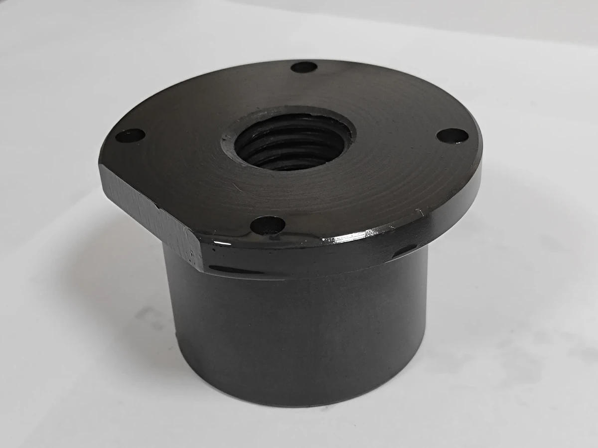 Dark phosphate-finished cylindrical component with an internally threaded flange