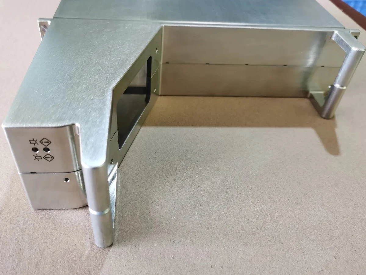 Zinc-finished metal enclosure with machined openings and corner posts