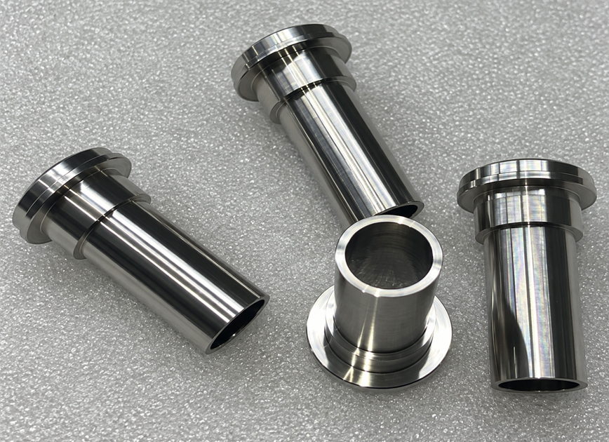 Polished metal sleeves with flanged ends and hollow cylindrical bores