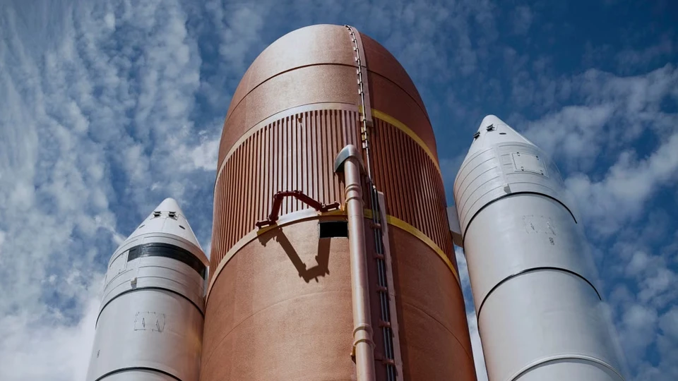 Space launch vehicle tank and boosters against a blue sky
