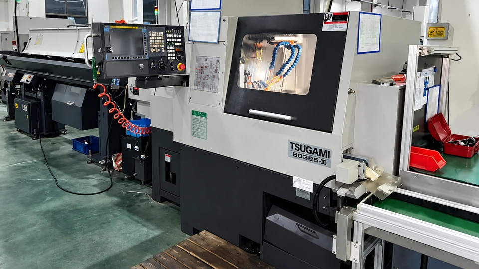 TSUGAMI Swiss-type CNC lathe with bar feeder, control panel and machining enclosure