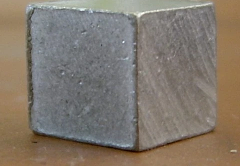 An aluminum square billet with straight edges and visible surface texture