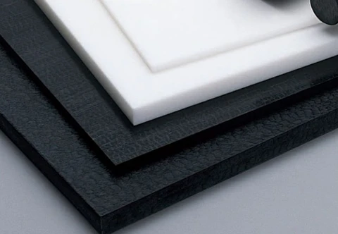 Stacked rectangular black and white polymer stock with straight cut edges