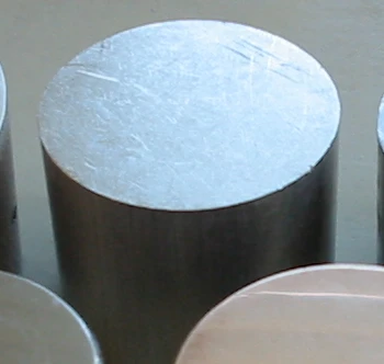 Short cylindrical metal blank with a bright sawn end face