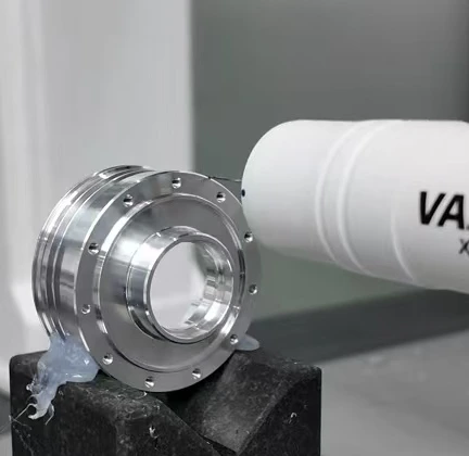 A coordinate measuring probe inspecting a machined metal ring with drilled flange holes