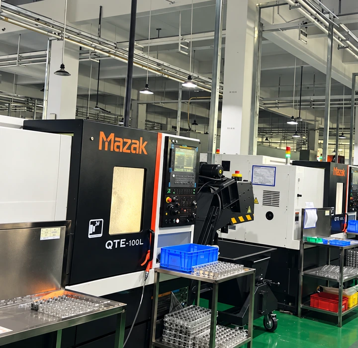 Rows of Mazak machine tools and workstations inside a machining workshop