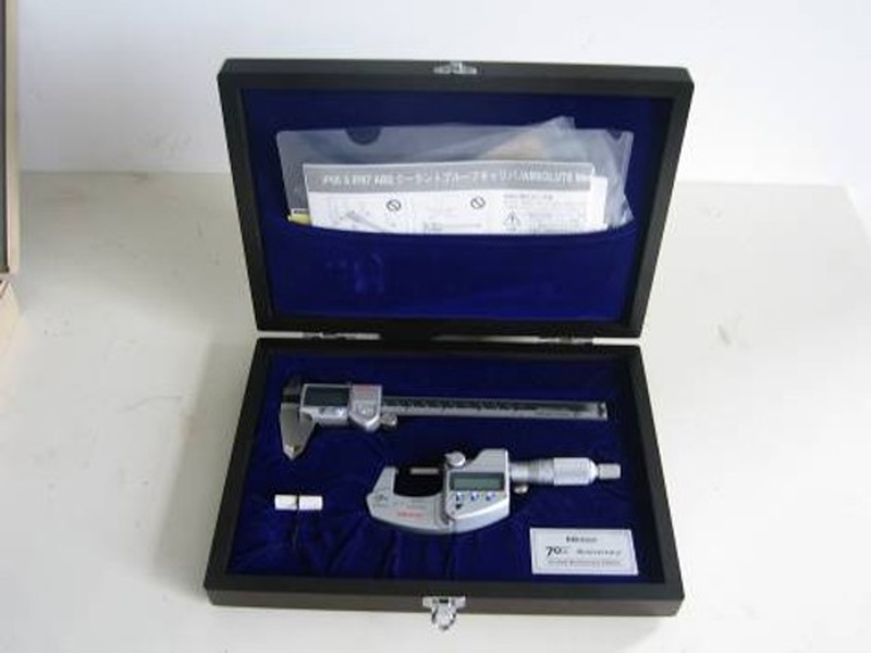 Digital caliper and outside micrometer together in a blue-lined instrument case