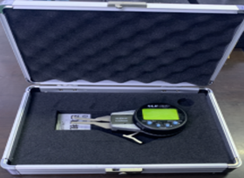 Digital internal caliper gauge with measuring arms and electronic display in a foam-lined case