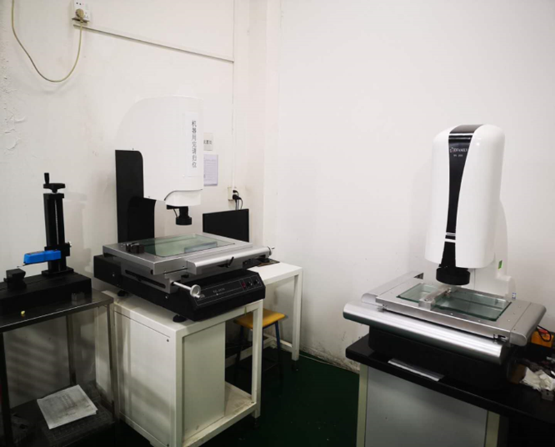 Two optical video measuring machines with glass stages in the factory measurement room