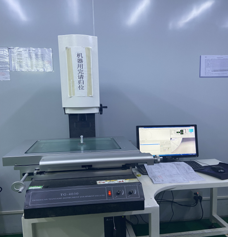2.5D video measuring machine with glass measuring stage and adjacent computer monitor