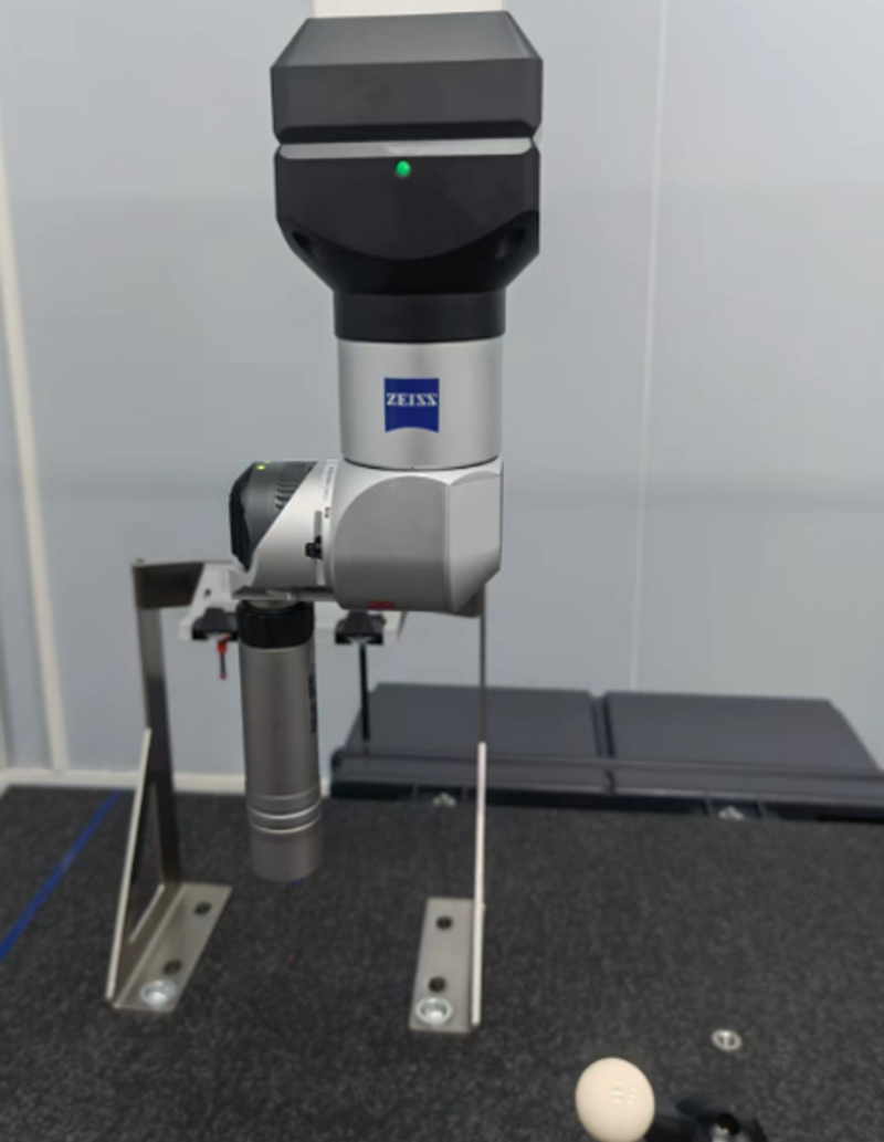 Close view of the ZEISS CMM probe head and stylus above the granite measuring table