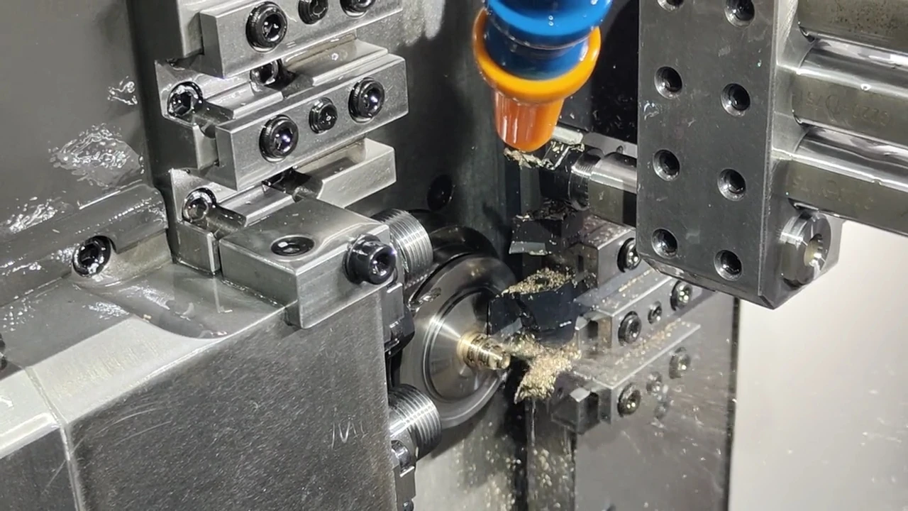 Swiss machining tooling cutting a small metal bar inside the machine